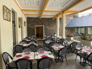 a row of tables and chairs at a restaurant at Grand Hôtel du Parc in Florac