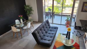 a living room with a couch and a table at Apartamentos Borbon Suites in Medellín
