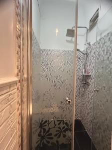 a shower with a glass door in a bathroom at Panoramic terace Victory boutique in Bucharest +33 photos