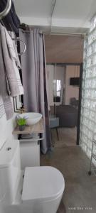 a bathroom with a white toilet and a sink at Corredera Travel 2 in Córdoba +10 photos