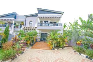 a house with a staircase in front of it at Lux Holidays Villa in Kigali