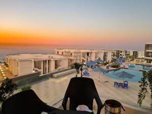 a view of the pool at a resort at sunset at السخنة هيلز مدينة الجلالة Sokhna Hills Al Galala City Family only in Ain Sokhna