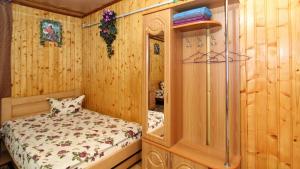 a bedroom with a bed in a wooden room at Апартаменти з терасою in Yablunytsya