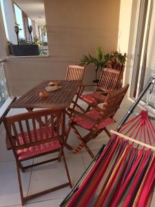 una mesa de madera y sillas en un porche en Ocean Dream BeachHouse Boa Vista, en Sal Rei