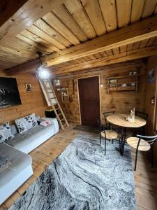 a room with a couch and a table in a room at Vikendica Davidović in Berane