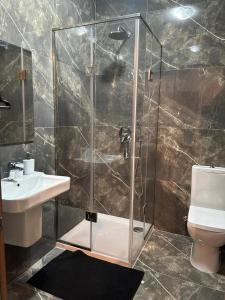 a bathroom with a shower and a sink and a toilet at Bella Qawra Maisonette in St. Paul's Bay +6 photos