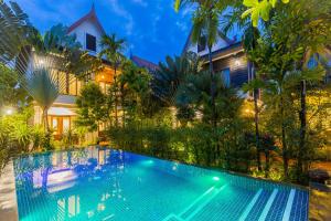 an image of a swimming pool in front of a villa at Golden Vishnu Villa in Siem Reap