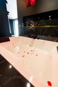 a white bath tub with blood on the floor at Suite D&S Luxury Room in Firminy