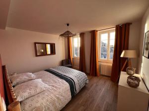a bedroom with a bed and a window at Maison pour 10 personnes max en plein centre de Ste Mère Eglise in Sainte-Mère-Église