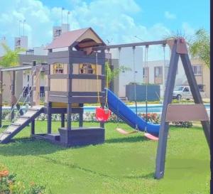 a playground with a slide in a park at Ela in Playa del Carmen