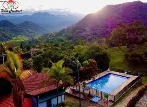 a house with a swimming pool and a mountain at Villa Cristina San Javier in La Mesa