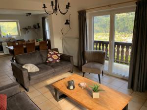 a living room with a couch and a table at Haus Brunner in Döbriach