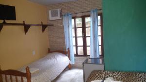 a bedroom with two beds and a window at Pousada Viva Mar in Saquarema +37 photos