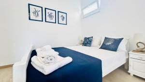 a bedroom with a white bed with towels on it at Mirem Boutique Apartments, Central Apartments in Ofrínion
