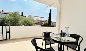 a patio with a table and chairs on a balcony at Mirem Boutique Apartments, Central Apartments in Ofrínion