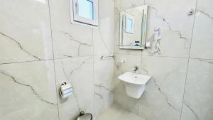 a white bathroom with a sink and a mirror at Mirem Boutique Apartments, Central Apartments in Ofrínion +46 photos