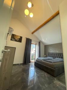 a bedroom with a bed and a large window at Charmante Ferienwohnung im Herzen Tirols in Hatting