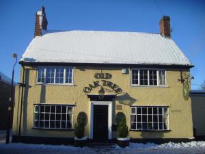 a yellow building with a sign on it at Old Oak Tree in Thirsk