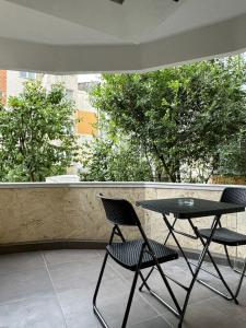 two chairs and a table on a balcony at Karlsburg Apartament in Alba Iulia