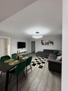 a living room with a couch and a table at Karlsburg Apartament in Alba Iulia