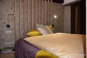 a bedroom with a large bed with yellow pillows at Moulin de Schwabwiller in Schwabwiller