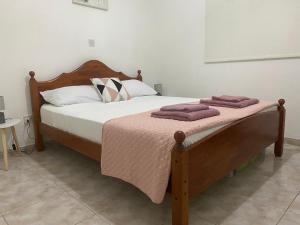 a bed with two pillows on it in a bedroom at Polis Chrysochous Entire Apartment in Polis Chrysochous