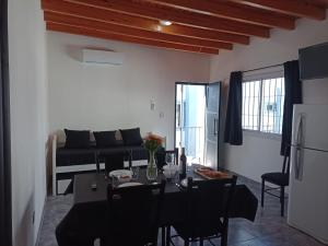 a living room with a table and a couch at RyM Departamentos in Barraquero