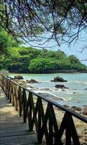 uma ponte de madeira sobre uma praia com o oceano em APTO BEIRA MAR BALNEARIO CAMBORIU no Balneário Camboriú