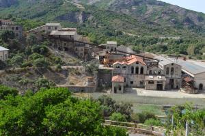 an old town on a hill with a mountain at Casa vacanze Costa Verde, Guspini, Sardegna in Guspini