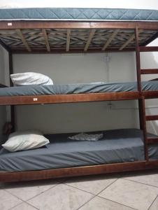 two bunk beds in a room with a blue mattress at Hostel em Copa in Rio de Janeiro