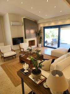 a living room with a couch and a table at Villa Solaris in Sounio