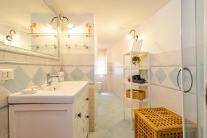 a white bathroom with a sink and a shower at Luna Prime Collection Catania in Catania