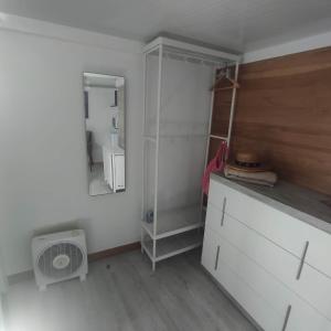 a kitchen with a white refrigerator and a mirror at Habitación Namasté in Playa Blanca