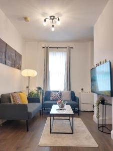 a living room with two couches and a tv at Amber Lodge- No party Room in Belfast
