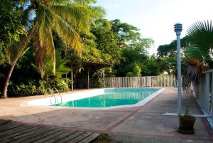 a swimming pool in a yard with a fence at Bohemian Lodge - Artist's Boutique in Kingston