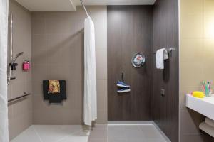 a bathroom with a shower and a sink at Moxy Aberdeen Airport in Dyce
