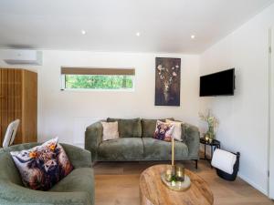 a living room with a couch and a table at Lodge in Hattemerbroek near Veluwe Forest in Hattemerbroek