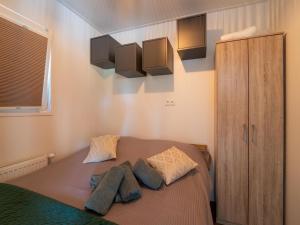 a bedroom with a bed with two pillows at Lodge in Hattemerbroek near Veluwe Forest in Hattemerbroek