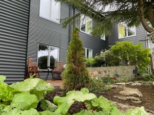 a house with a garden in front of it at Úti í Kina in Tórshavn