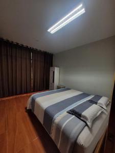 a bedroom with a large bed in a room at 1era Habitación privada a 1 cuadra del parque in Oxapampa