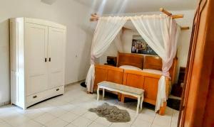 a bedroom with a bed with a canopy at Holiday Home Kotulin in Pakoštane