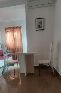 a dining room with a table and two chairs at Apartments Danilo Kažanegra in Sveti Stefan