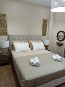 a bedroom with a bed with two towels on it at Nikola's & Joanna's apartments in Argostoli