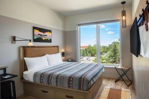 A bed or beds in a room at Moxy Boulder