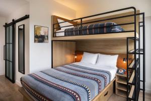 A bed or beds in a room at Moxy Boulder
