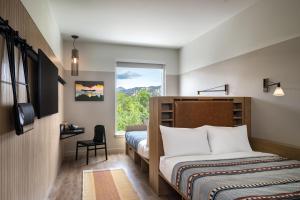 A bed or beds in a room at Moxy Boulder