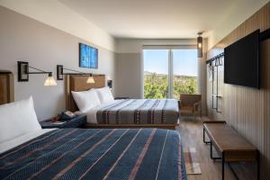 A bed or beds in a room at Moxy Boulder