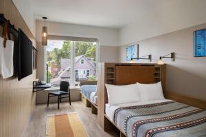 A bed or beds in a room at Moxy Boulder