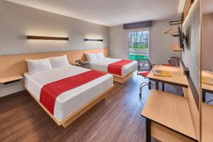 a hotel room with two beds and a desk at City Express by Marriott Lagos de Moreno in Lagos de Moreno +55 photos