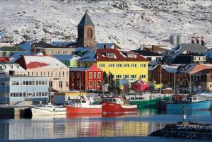a group of boats docked in a harbor with a city at Sea Captains Cabin in Lamaline